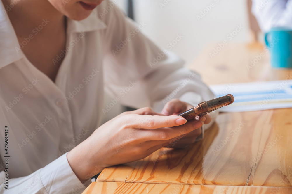 Cropped shot of business woman using smart phone for online shopping
