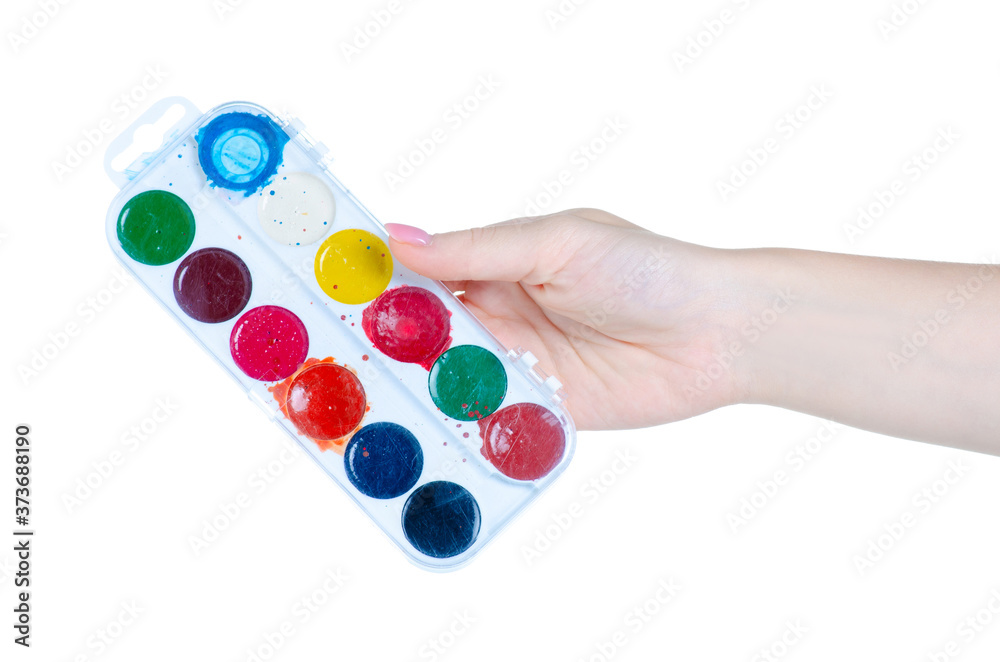 watercolor paints palette in hand on white background isolation