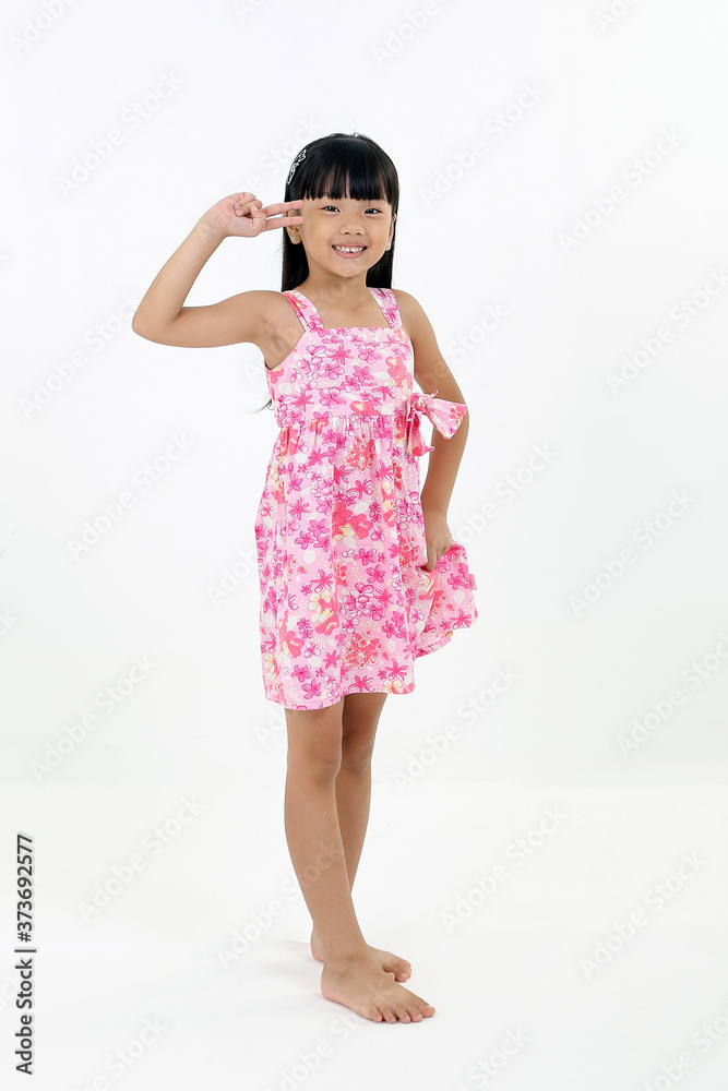 South East Asian young girl child playing happy waving hand v finger on white background South East Asian young girl child playing happy waving hand v finger on white background