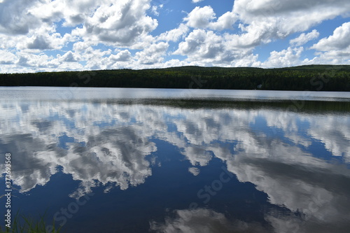 Fototapeta Naklejka Na Ścianę i Meble -  The reflection of the clouds on the square lake, Sainte-Apolline, Quebec