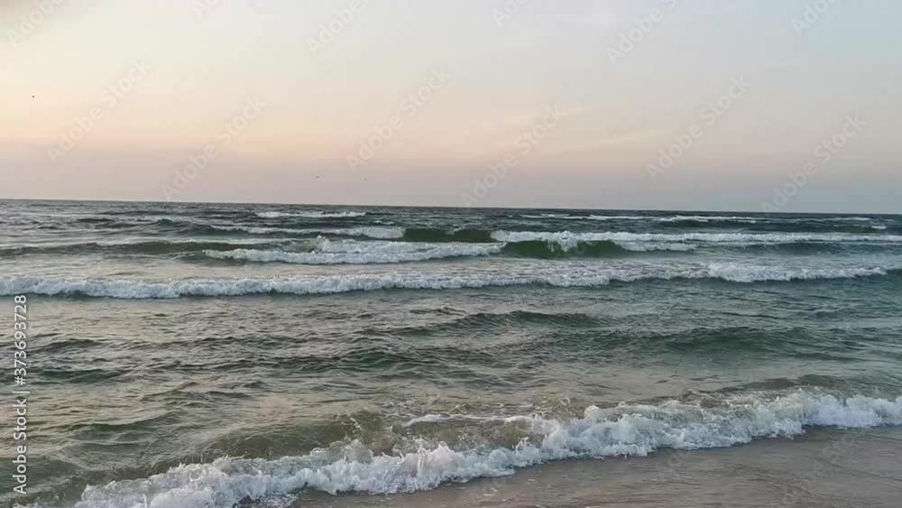 Waves on a beach on a windy day at the Baltic Sea.
