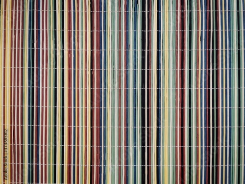 Napkins striped background from different colours bamboo scroll. Close up. Top view. 