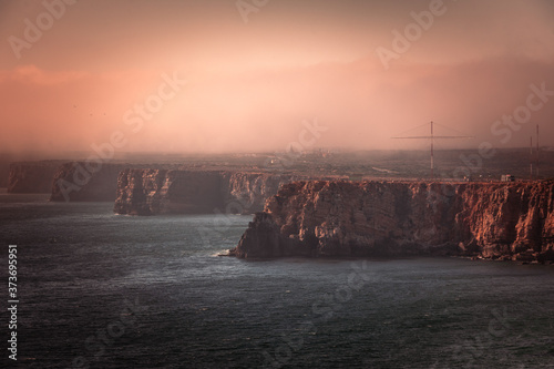 High red cliffs around Sao Vicente cape at south-west corner of Portugal, at the Algarve region.