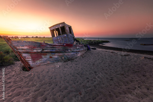 Abandoned boat at Carrasqueira's palafitic sea port. A traditional maritime port for local fishermen. photo