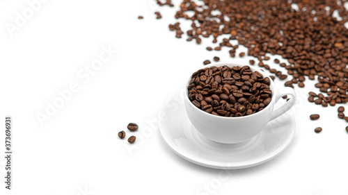 A Cup with coffee beans on a white background. Lots of coffee beans. High quality photo