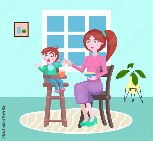 Mother feeding her little son with a poridge or other meal sitting in children s chair. Boy denying food don t want to eat and crying. Angry mother try to give food to her child. Parenthood concept