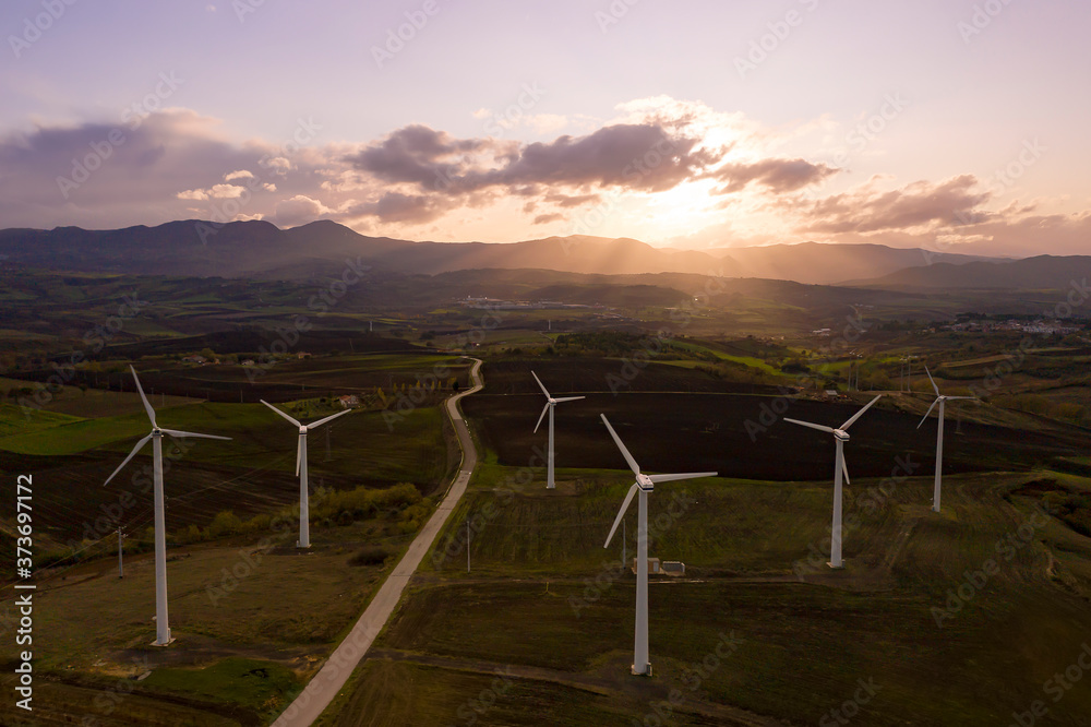 Fototapeta premium Wind turbines at the sunset