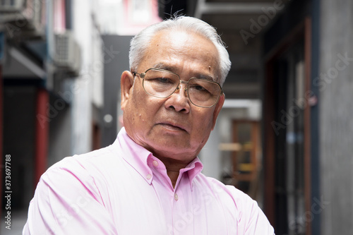 stressed, angry asian old senior man photo