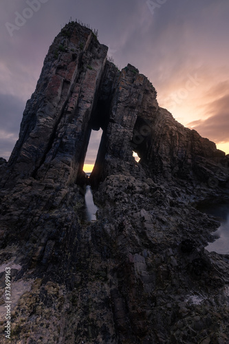 Sunset at Vallina beach amazing rocky beach at the coast of Asturias, north of Spain. photo