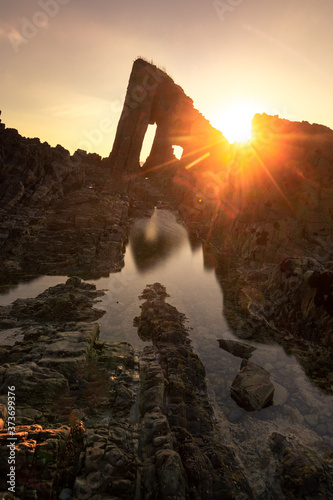 Sunset at Vallina beach amazing rocky beach at the coast of Asturias, north of Spain. photo