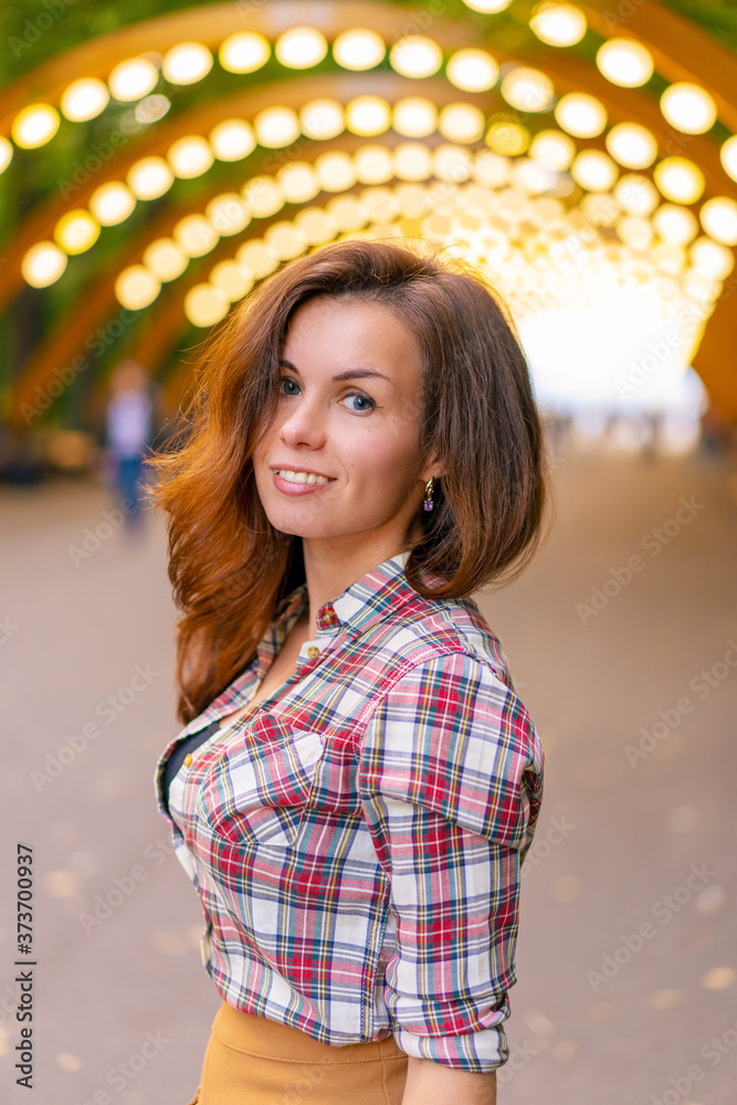 Portrait of a young girl in a shirt in Sokolniki Park in Moscow under an arch with lanterns Portrait of a young girl in a shirt in Sokolniki Park in Moscow under an arch with lanterns