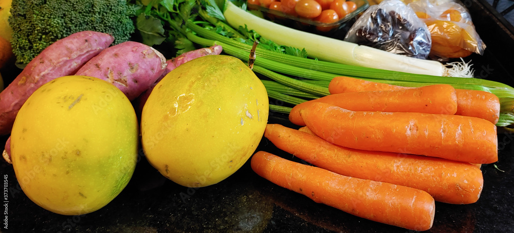 A small variety of fruits and vegetables that have just arrived from the organic fair.