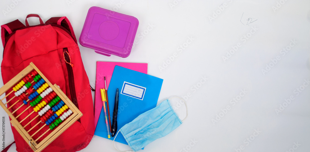 backpack, food box, notebooks, pens, abacus and sanitary mask on a white background backpack, food box, notebooks, pens, abacus and sanitary mask on a white background