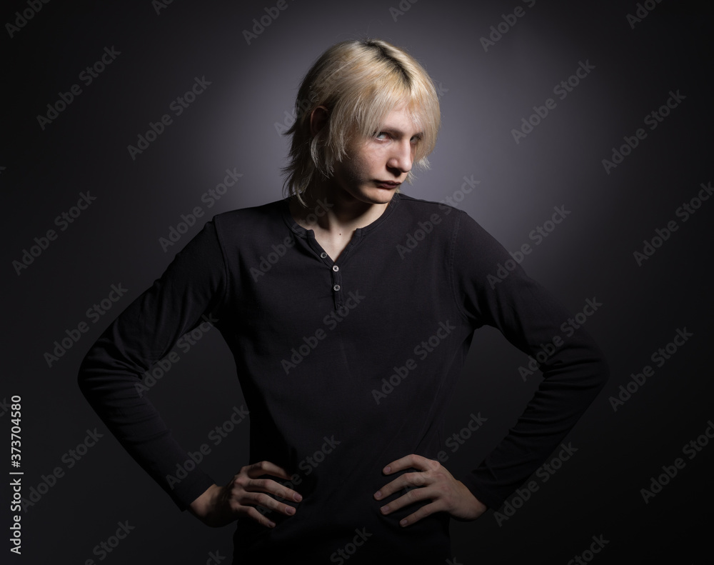Portrait of a young stylish man with white hair on a black background. Portrait of a young stylish man with white hair on a black background.
