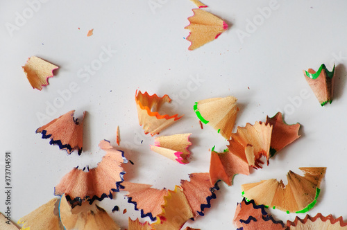 Close-up picture of pencil peels from sharpening colored pencils on a light background