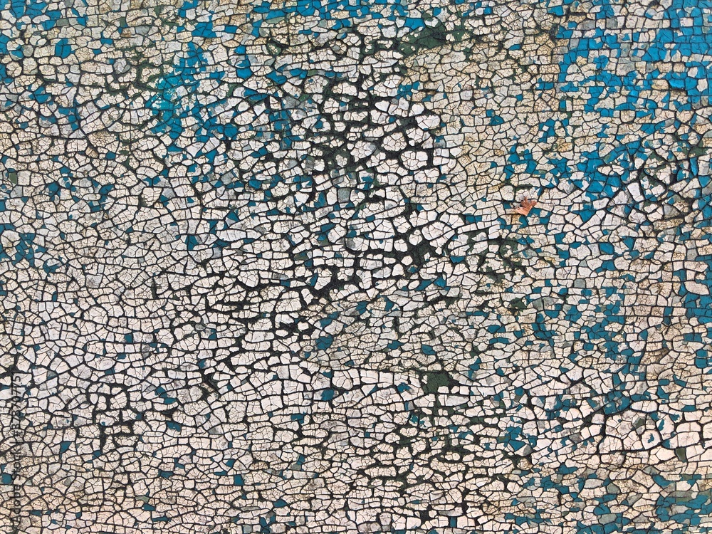 Fototapeta premium Background of white, peeling paint on an old wall