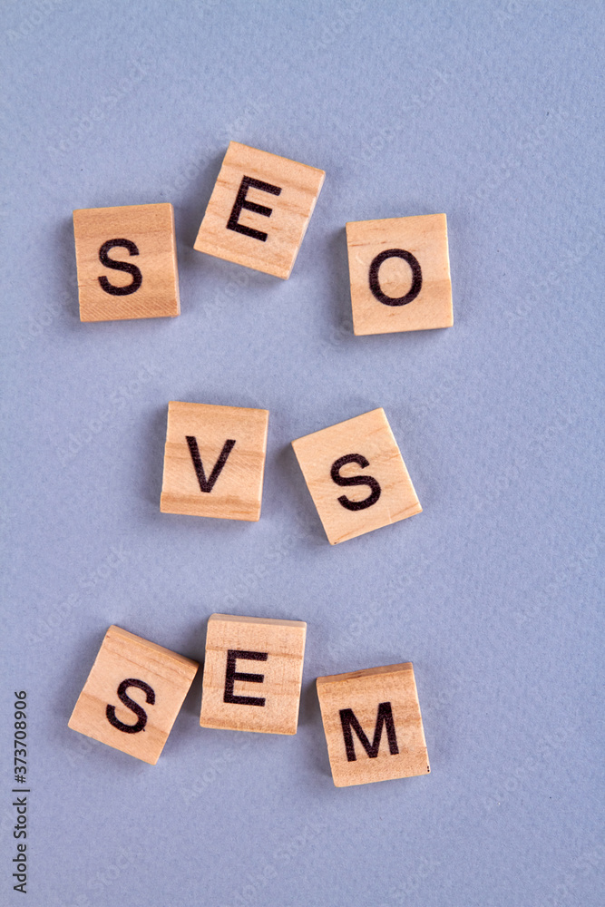Seo vs sem concept. Letters written on wood block isolated on gray background. Web marketing symbols. Search engine optimization abbreviation. Seo vs sem concept. Letters written on wood block isolated on gray background. Web marketing symbols. Search engine optimization abbreviation.