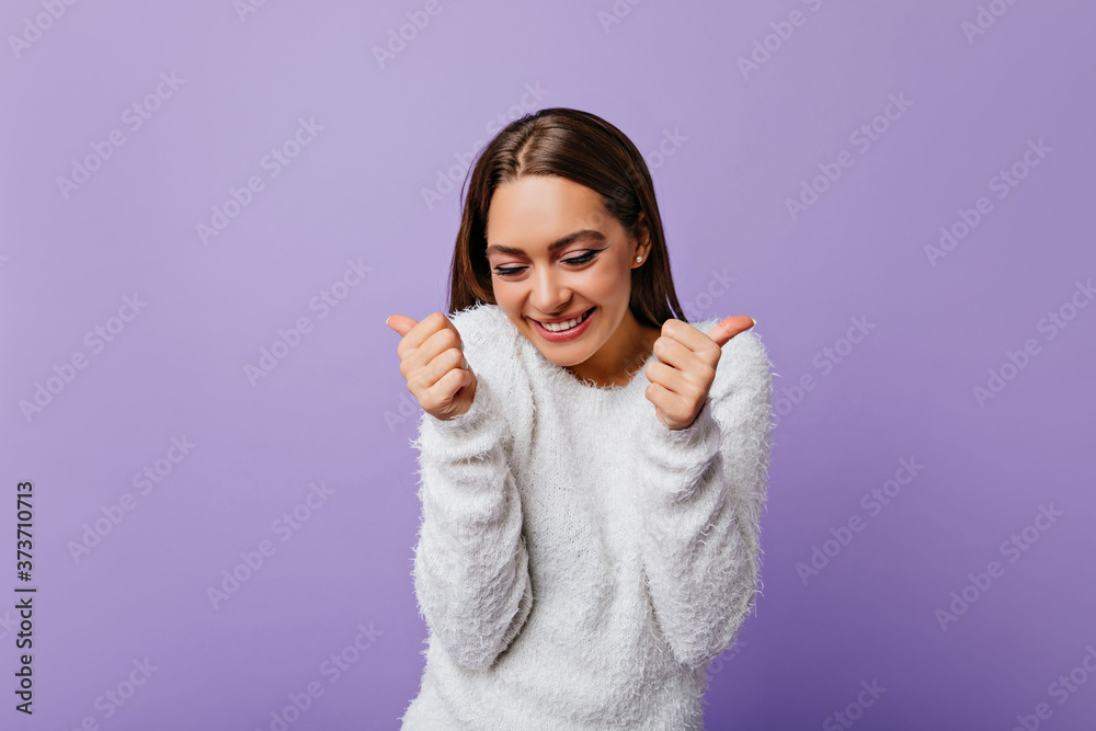 creative, absolutely happy model rejoices in victory, showing that she is fine. Portrait of dark-haired girl with pretty face posing in studio creative, absolutely happy model rejoices in victory, showing that she is fine. Portrait of dark-haired girl with pretty face posing in studio