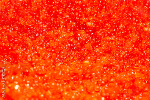 Background of salmon and trout red caviar. Seafood. Expensive delicatessen from sea. Macro shot , focus on a center