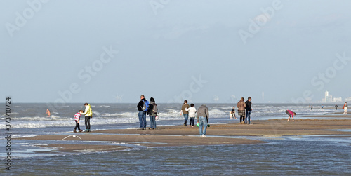 Autumn at the beach near Noordwijk;  on the horizon smoke stacks in IJmuiden and buildings of Zandvoort