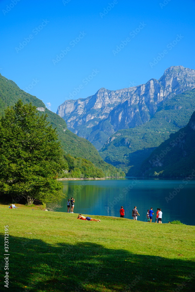 The Lago del Mis is lake in Belluno, Veneto, Italy,  looks very beautiful with its green colors. It's morning and sunrise. Beautiful italian nature. 