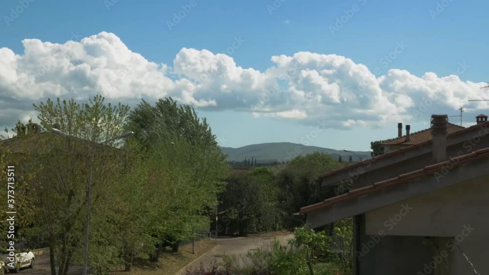 Nice shape clouds running on sky, in a Tuscany town. Montepulciano. Clouds background Nice shape clouds running on sky, in a Tuscany town. Montepulciano. Clouds background