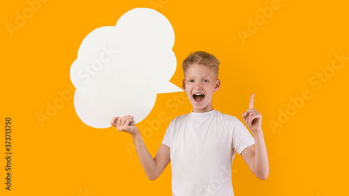 Smiling teenage boy pointing up at speech bubble