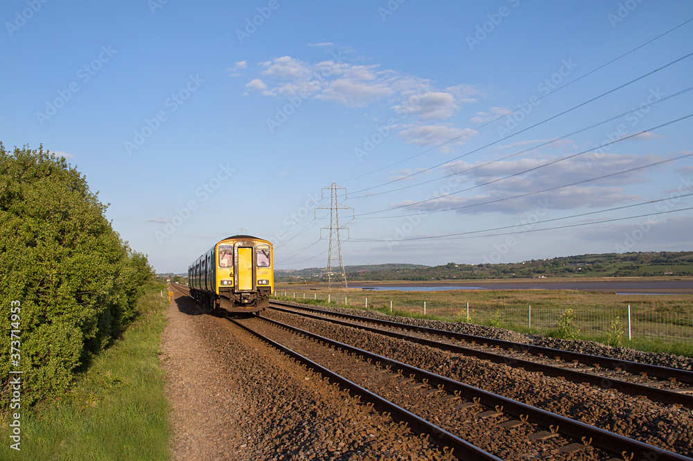 Swansea, UK: May 04, 2017: Arriva train traveling on a local line along ...