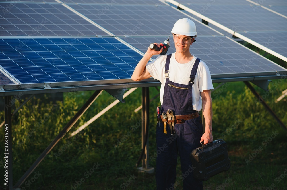 Worker installing solar panels outdoors Worker installing solar panels outdoors