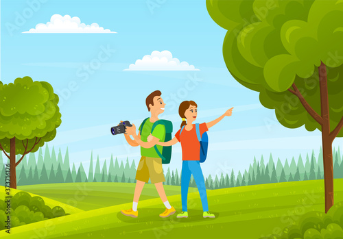 Tourists man and woman with camera in forest summer time. Family holiday, husband and wife with backpacks are hiking in green nature landscape, happy smiling people take pictures of beautiful places