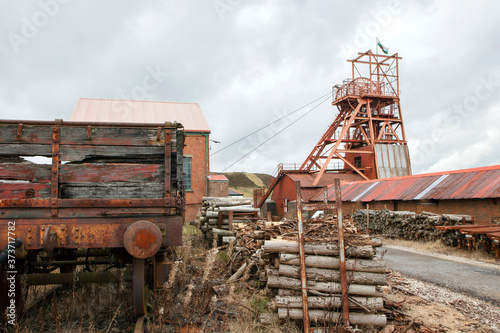 Big Pit was a working coal mine from 1880 to 1980. It is now obsolete and closed. Exterior of an old building with broken and discarded machinery scattered on the ground.