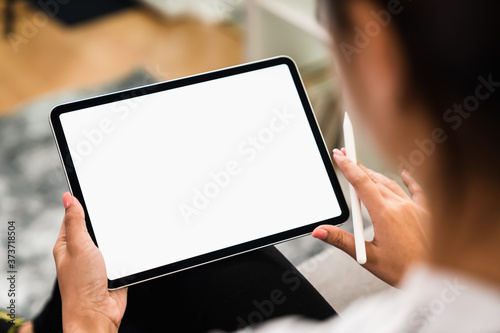 Young woman holding digital tablet with a blank screen, for putting advertising to promote.