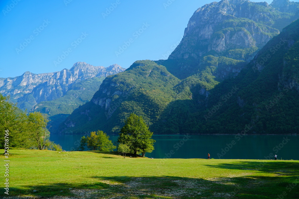 The Lago del Mis is lake in Belluno, Veneto, Italy,  looks very beautiful with its green color. It's morning and sunrise. Beautiful Italian nature. The Dolomites are a mountain range located in Italy