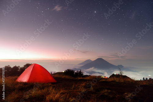 Camping on the mountain with a beautiful view of the mountains and stars at sunrise