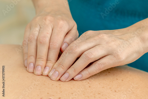 Back massage with hands in the SPA. Close up