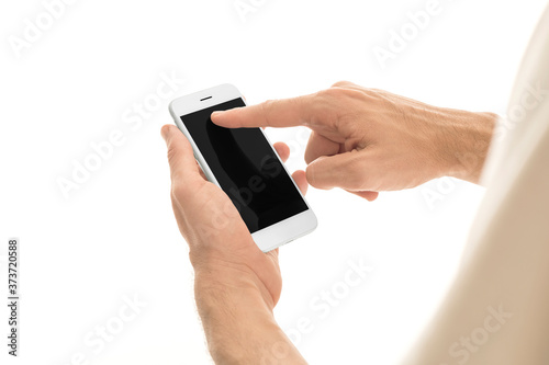 Man holding a smartphone with empty black screen. Mobile phone in a vertical position in hands and isolated on white background. High quality studio shot. Man touching and using phone.