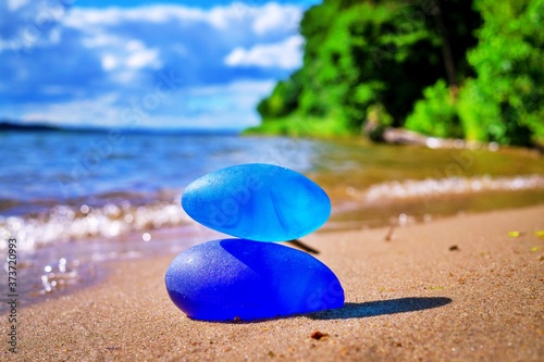 Photography Two blue stones balanced on tropical beach
