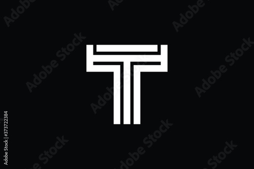 Minimal Innovative Initial T logo and TT logo. Letter T TT TTT creative elegant Monogram. Premium Business logo icon. White color on black background photo