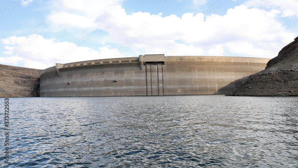 Double-curvature arch dam wall, Katse dam wall as seen from the river, Lesotho