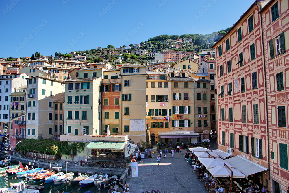 Colorful buildings and beach at Camogli on sunny summer day, Liguria, Italy