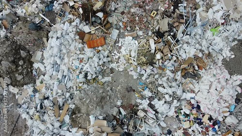 City landfill aerial shot,large smelly bags of trash and garbage building debris