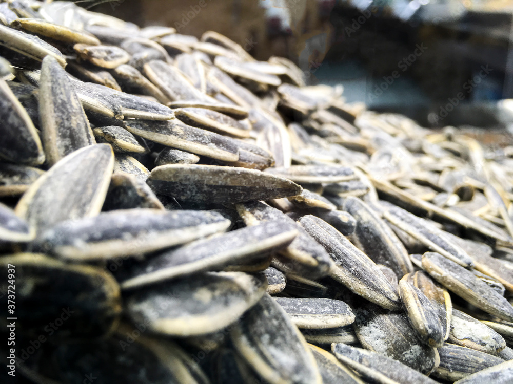 Close up shot of salted sunflower seeds(in TR: Ay cekirdegi) to be cracked for joy in the free time.