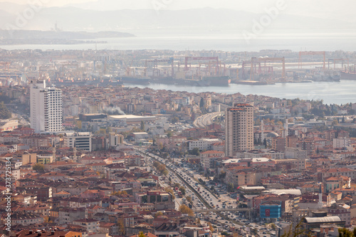 The Tuzla district of Istanbul has a lot of cranes to build ships and the main road of Istanbul is visible and in focus. Istanbul cityscape view from air.