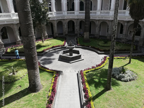 View from the top floor of fountain in museum. Pool in the garden, view from the top floor of the building, and trees in sunny day
