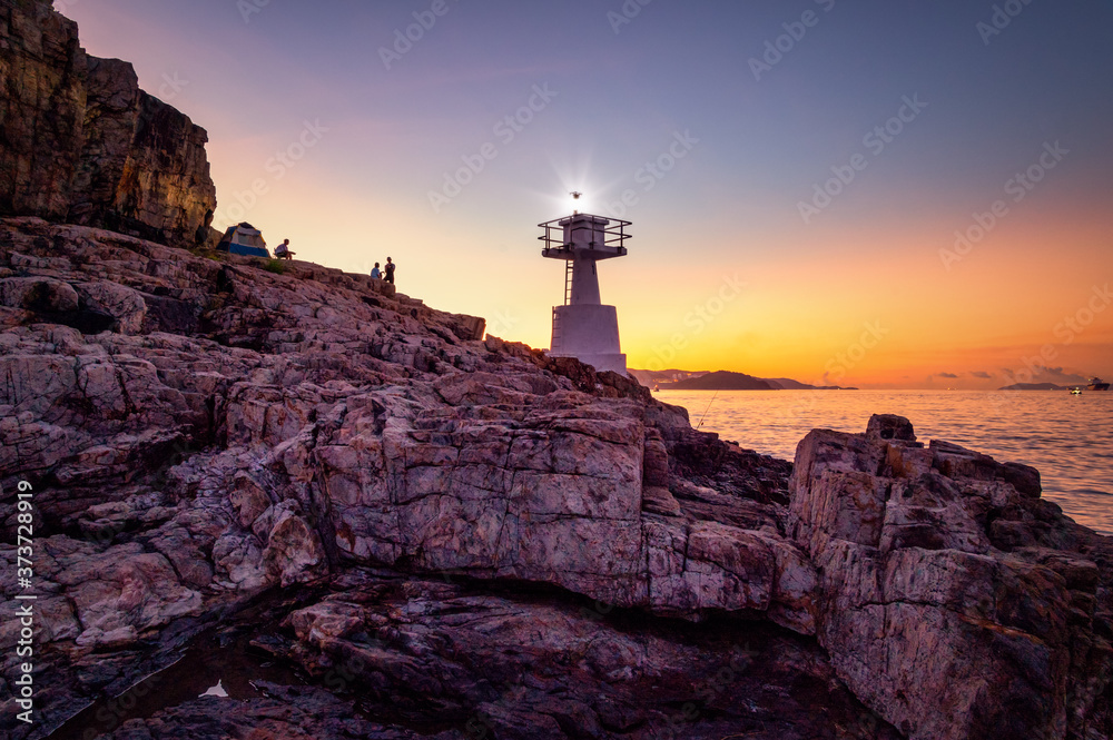 Mount Johnston Lighthouse at Ap Lei Pai beaming light ray in marine at night