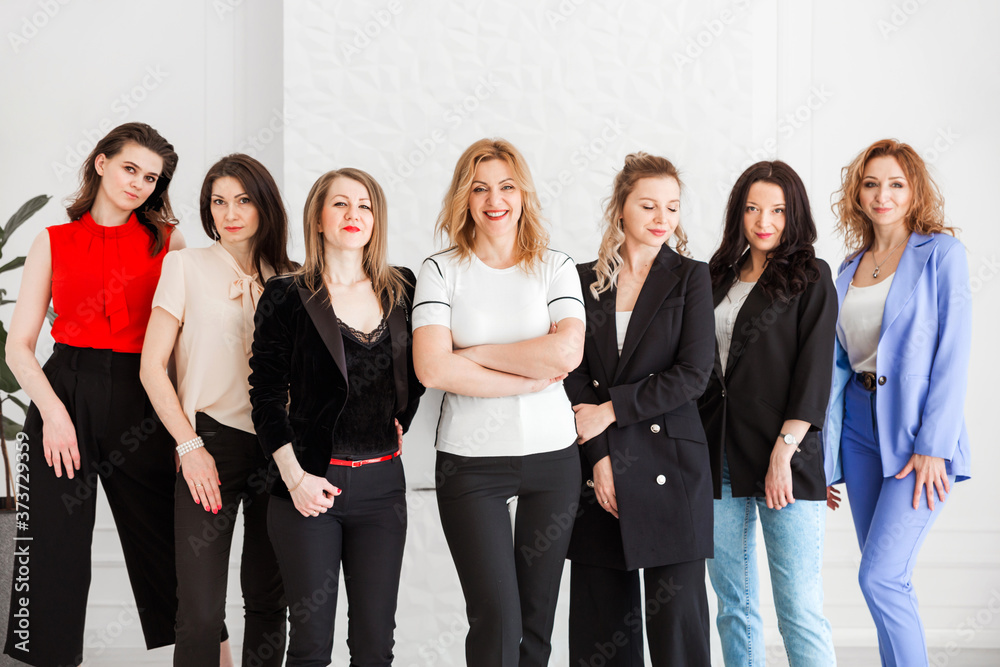 group of women dressed in business style posing and looking at the camera group of women dressed in business style posing and looking at the camera