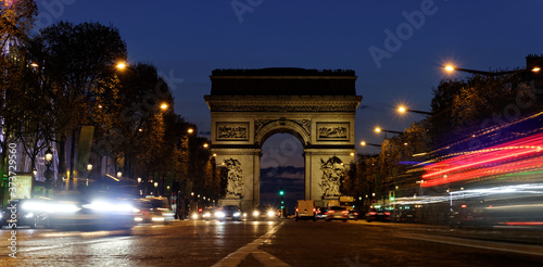 Arc de Triomphe, Paris city at night- Arch of Triumph and Champs Elysees with moving cars. Long exposure shot