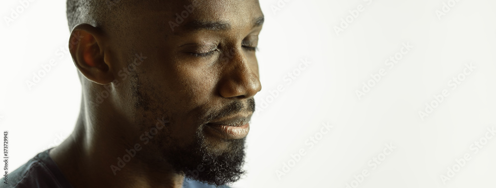 Calm. African-american young man's close up shot on studio background, flyer. Concept of human emotions, facial expression, sales, ad. Copyspace. Beautiful male model with bright expression. Calm. African-american young man's close up shot on studio background, flyer. Concept of human emotions, facial expression, sales, ad. Copyspace. Beautiful male model with bright expression.
