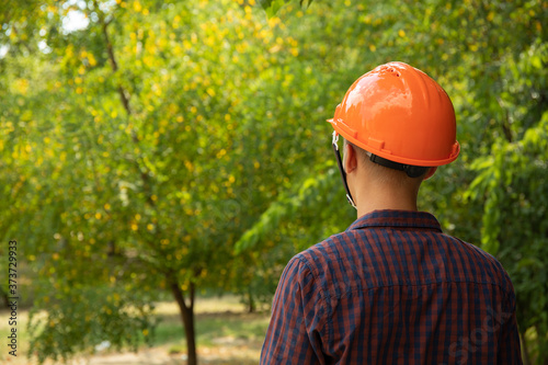 Builder in safety helmet outdoor, space for text