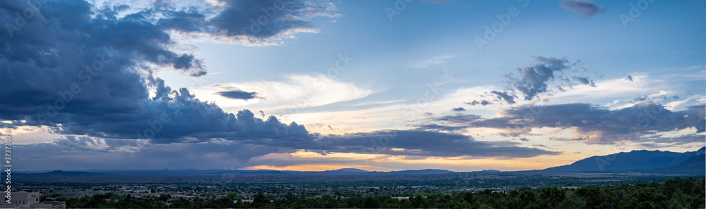 Εκτύπωση καμβά Panoramic sunset scene filled with blue skies and clouds in Taos, NM